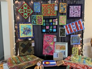 Fabric Strip Crafts. Use Fabric Strips to make a hanging background for your craft fair exhibit. 4-inch wide strips hung together to make and awesome background.